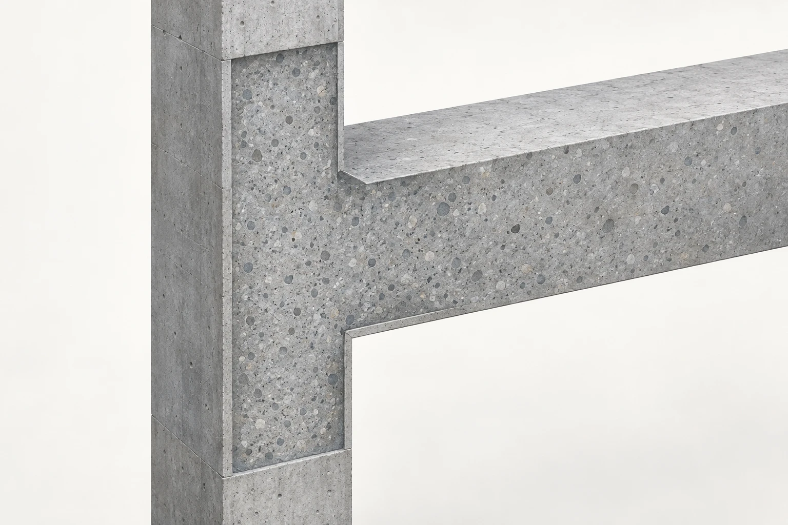 A monolithic concrete beam meets a vertical column at one cutaway joint core.
